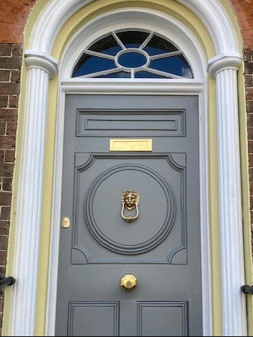 Polished brass auto-deadbolt nightlatch on a Georgian townhouse for secure, automatic locking.