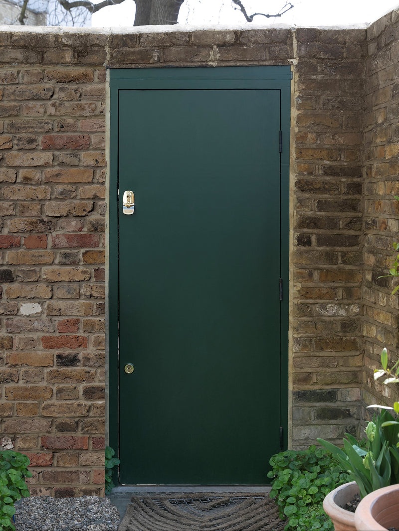 Polished brass auto-deadbolt nightlatch on an outward-opening door — ideal for busy street security